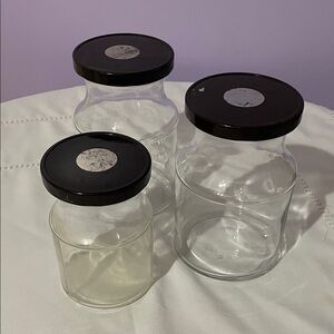 Set of Three Clear Glass Jars with dark brown Lids